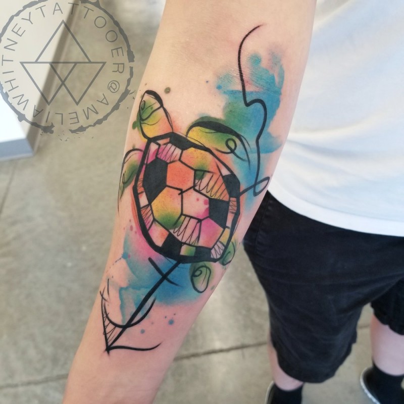 Watercolor turtle tattoo on forearm