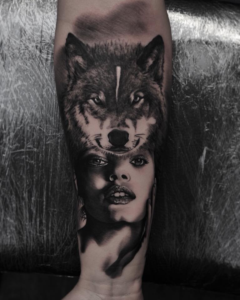 Wolf and woman tottoo on forearm