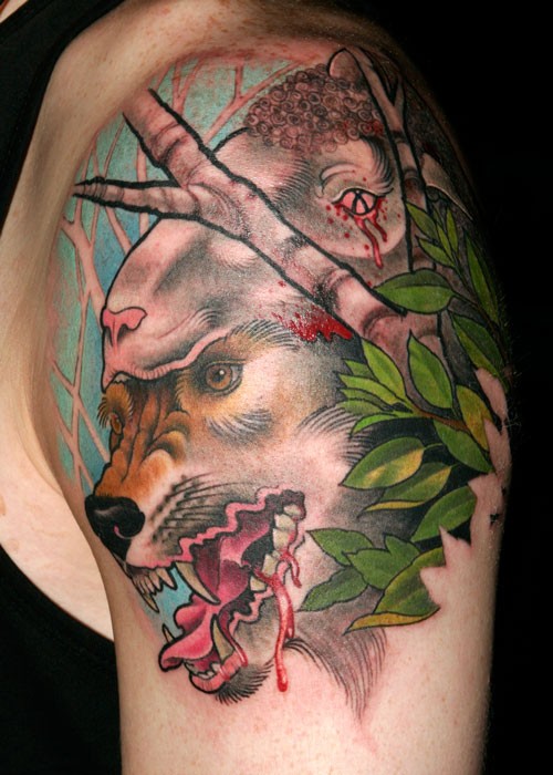 Wolf in sheep skin tattoo on upper arm