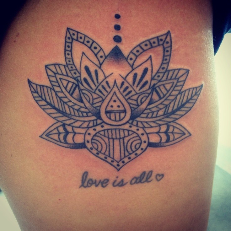 Wonderful black-ink tribal lotus flower tatto on back