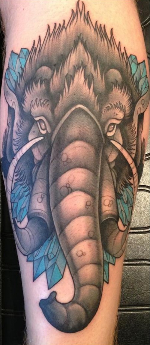 Wonderful colorful mammoth head tattoo on upper arm