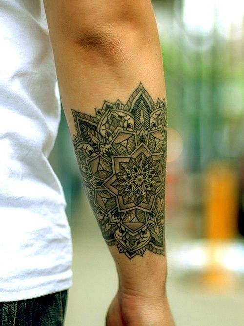 Wonderful uncolored flower mandala tattoo on forearm