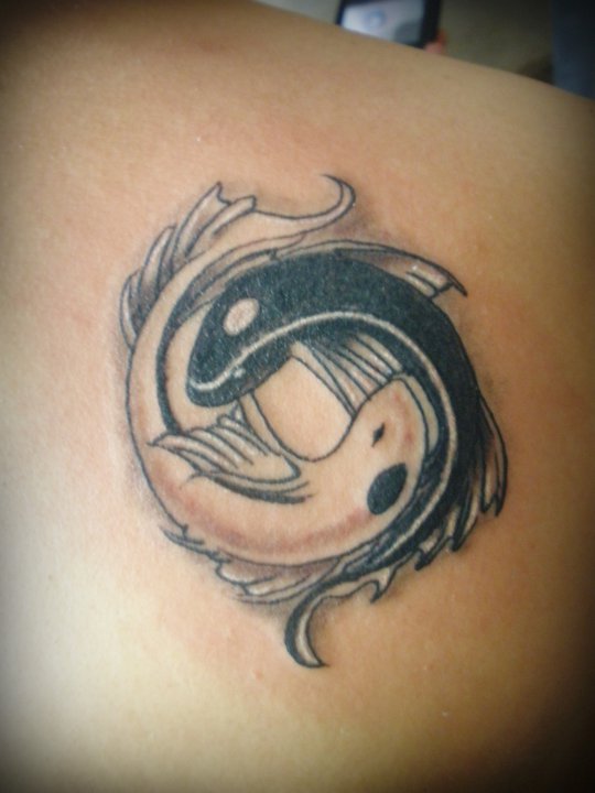 Tatuaje en el hombro, yin yang peces blanco y negro