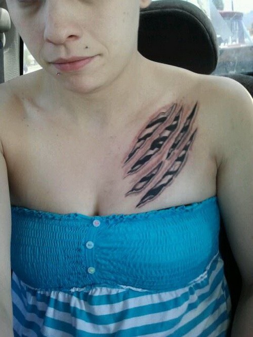 Zebra print scratches tattoo on chest