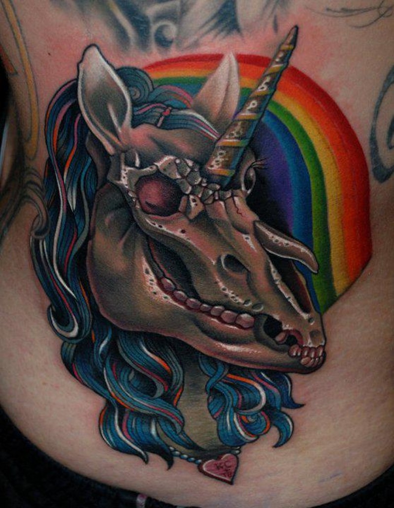 Tatuaje en la espalda baja, cráneo de unicornio volumétrico con arco iris