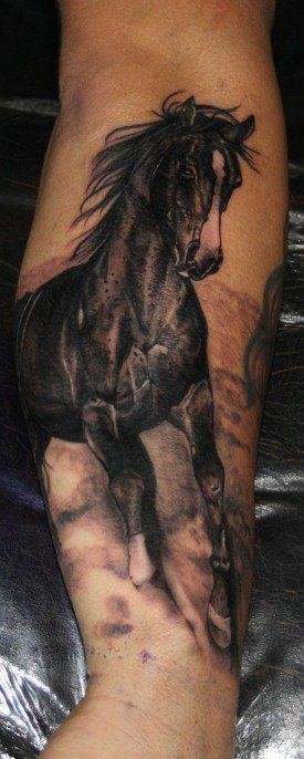 A horse at full gallop tattoo on arm