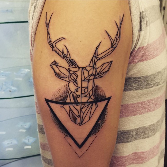 Abstract style black ink deer shaped tattoo on shoulder with black triangle