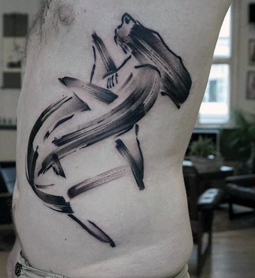 Abstract style black ink shark shaped side tattoo