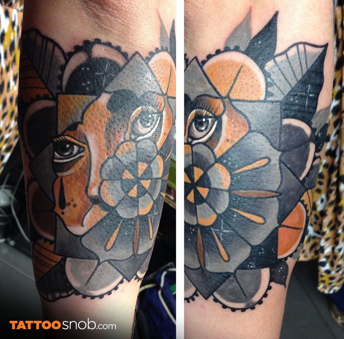 Abstract style colored arm tattoo of big geometrical flower and woman eyes