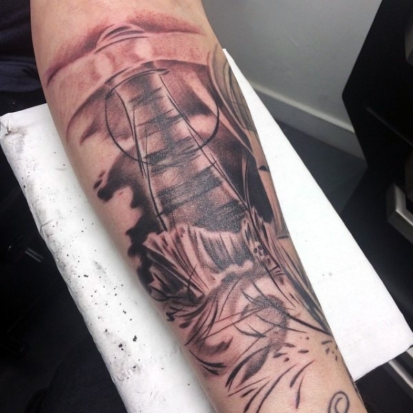 Abstract style colored forearm tattoo of lighthouse and waves