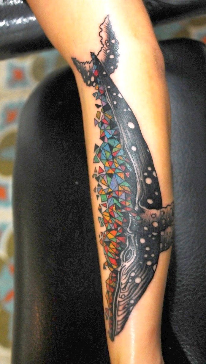 Abstract style colored forearm tattoo of big whale