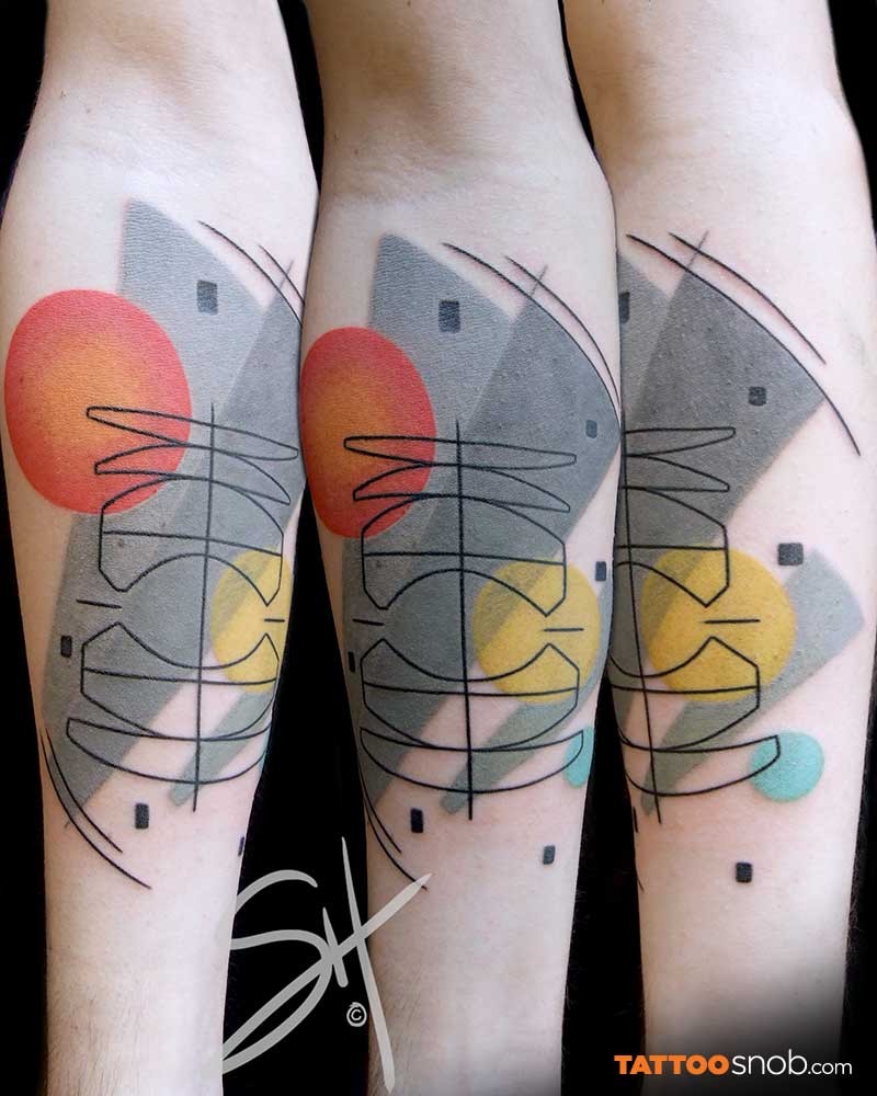 Abstract style colored forearm tattoo of various ornaments