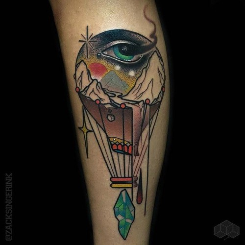 Abstract style colored forearm tattoo of big balloon with human eye