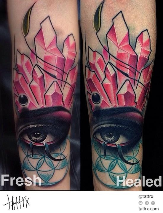 Abstract style colored forearm tattoo of woman eye with diamonds