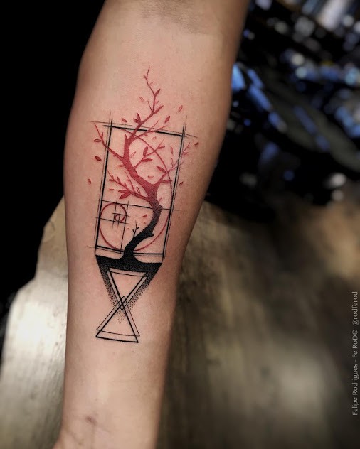 Abstract style colored forearm tattoo of geometrical figures with tree