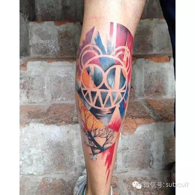 Abstract style colored leg tattoo of interesting ornaments