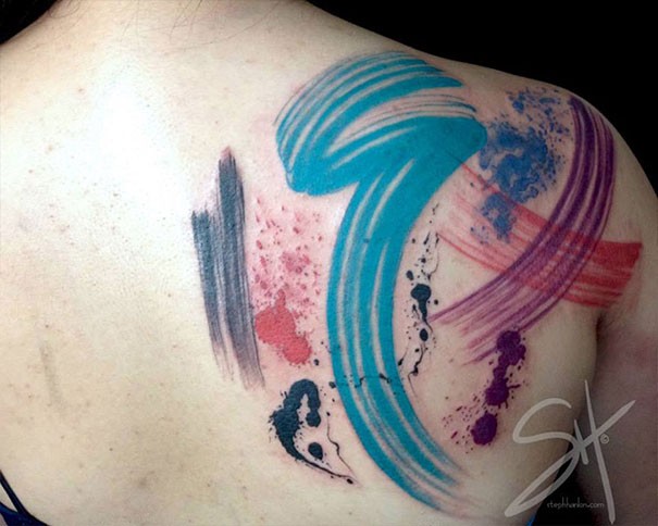 Abstract style colored shoulder tattoo of different lines