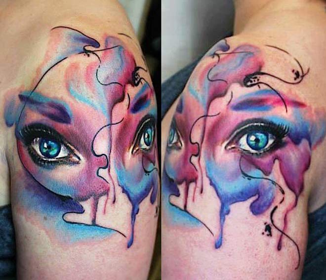 Abstract style colored shoulder tattoo of woman eyes