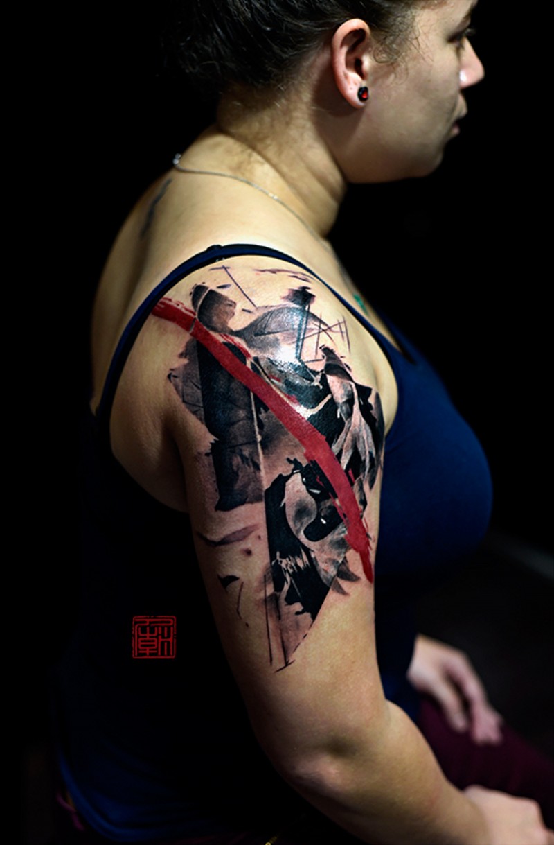 Abstract style colored shoulder tattoo with red line