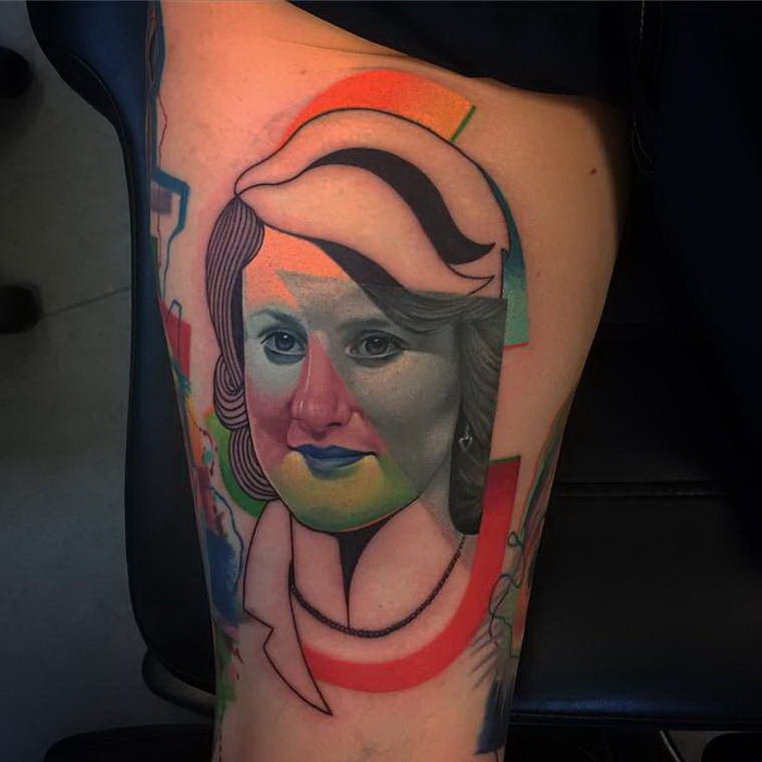 Abstract style colored thigh tattoo of woman portrait