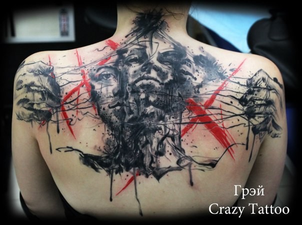 Abstract style colored upper back tattoo of human faces with tree