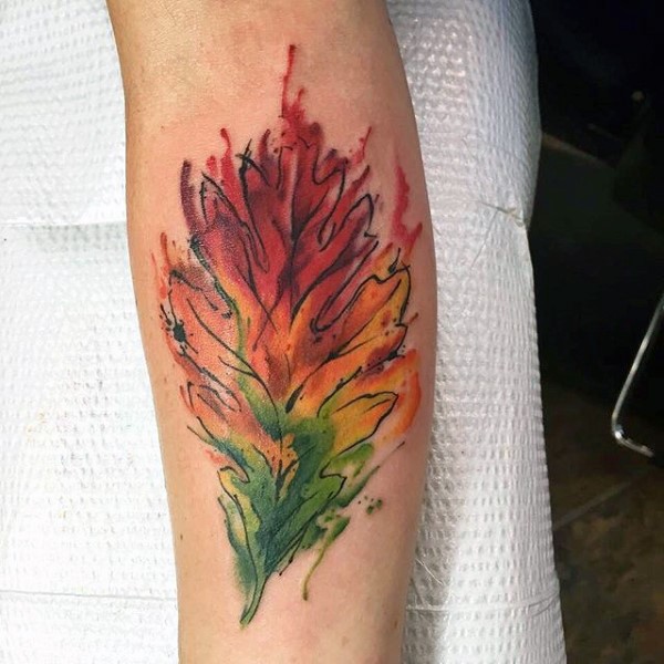 Abstract style colorful little leaf tattoo on arm