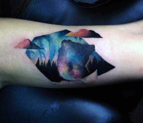 Abstract style colorful night tattoo on arm