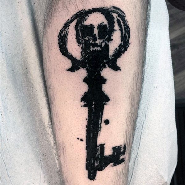Abstract style cool designed antic black ink key tattoo on leg