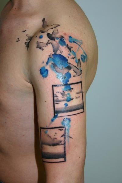 Abstract style medium size colored shoulder tattoo of picture with birds