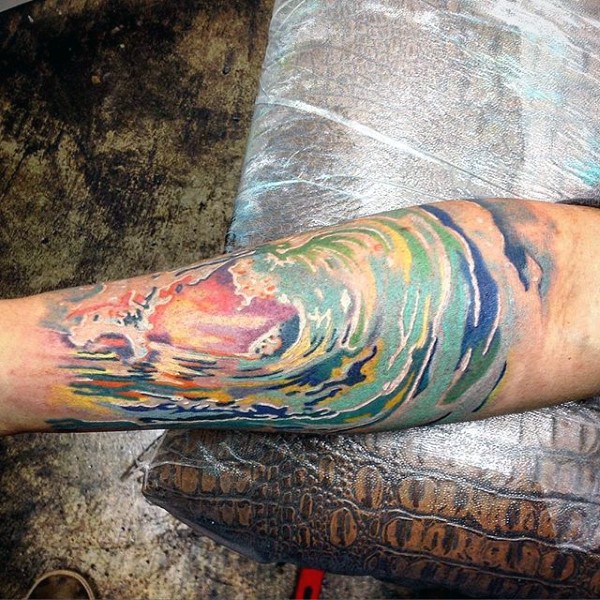 Abstract style multicolored ocean waves tattoo on arm