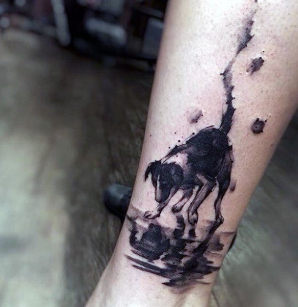 Abstract style painted black ink little dog tattoo on ankle