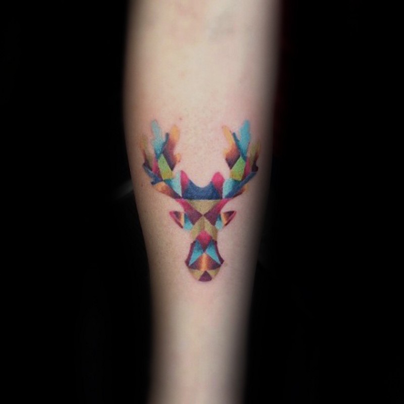 Abstract style tiny colored elk head shaped tattoo on forearm