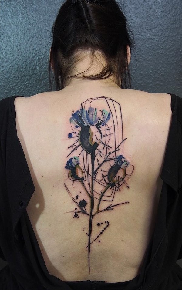 Abstract style watercolor like back tattoo of flowers