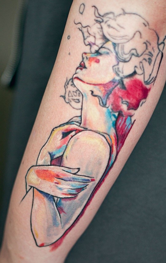 Abstract style watercolor like colored woman tattoo on arm