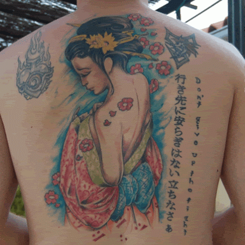 Accurate beautiful painted whole back Asian tattoo on woman with lettering