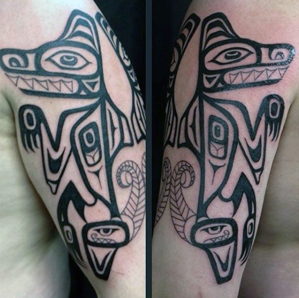 Accurate black ink tribal style shoulder tattoo