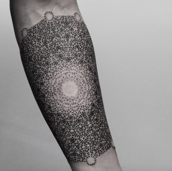 Accurate creative looking dot style forearm tattoo of floral ornament