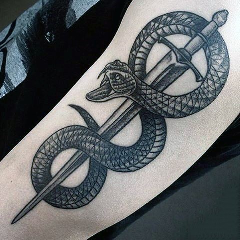 Accurate designed black and white snake with sword tattoo on arm