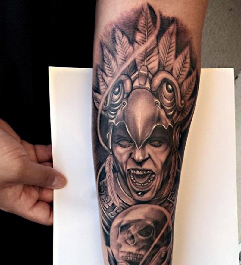 Accurate detailed looking black and white forearm tattoo of tribal pries and human skull