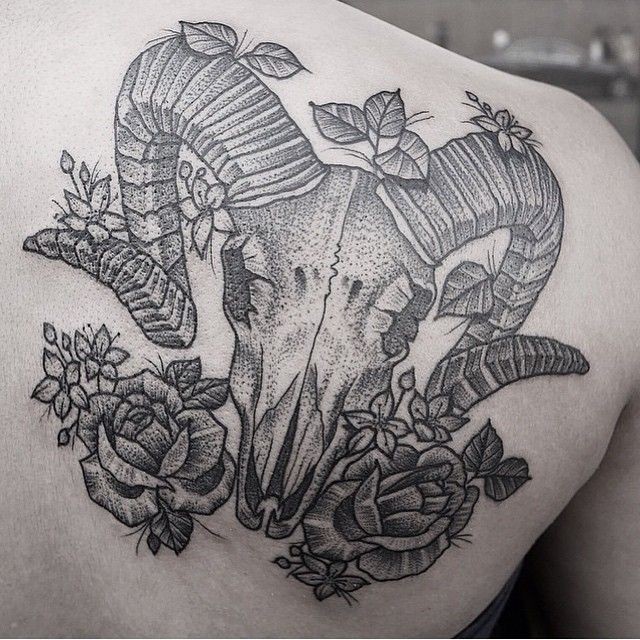 Accurate dot style scapular tattoo of animal skull and flowers