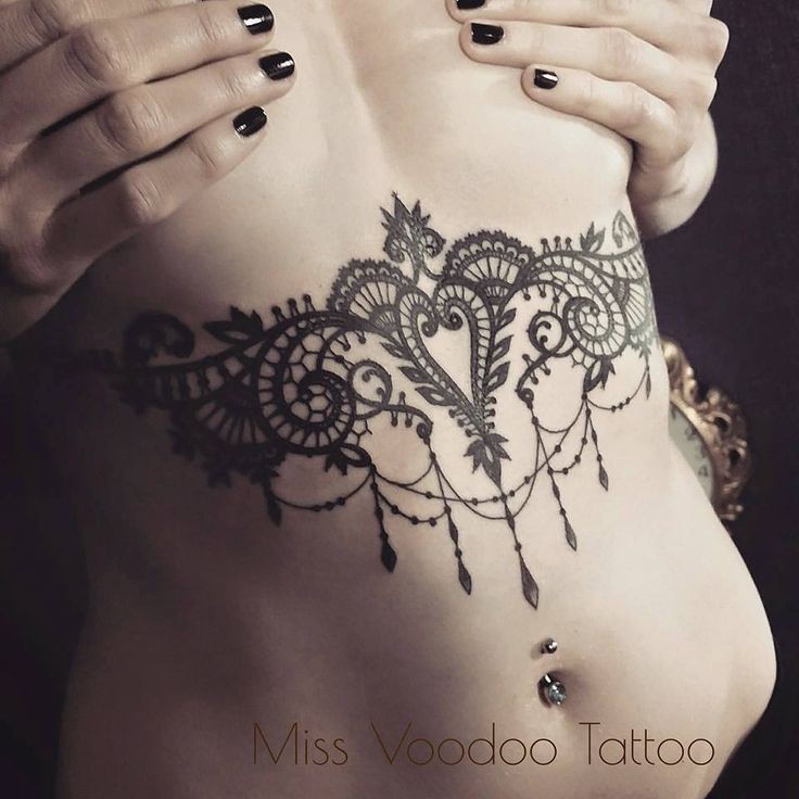 Accurate looking black ink belly tattoo of plant like jewelry painted by Caro Voodoo