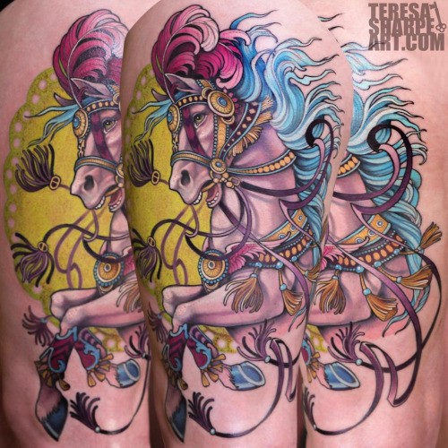 Accurate looking cartoon like colored fantasy horse tattoo on shoulder area