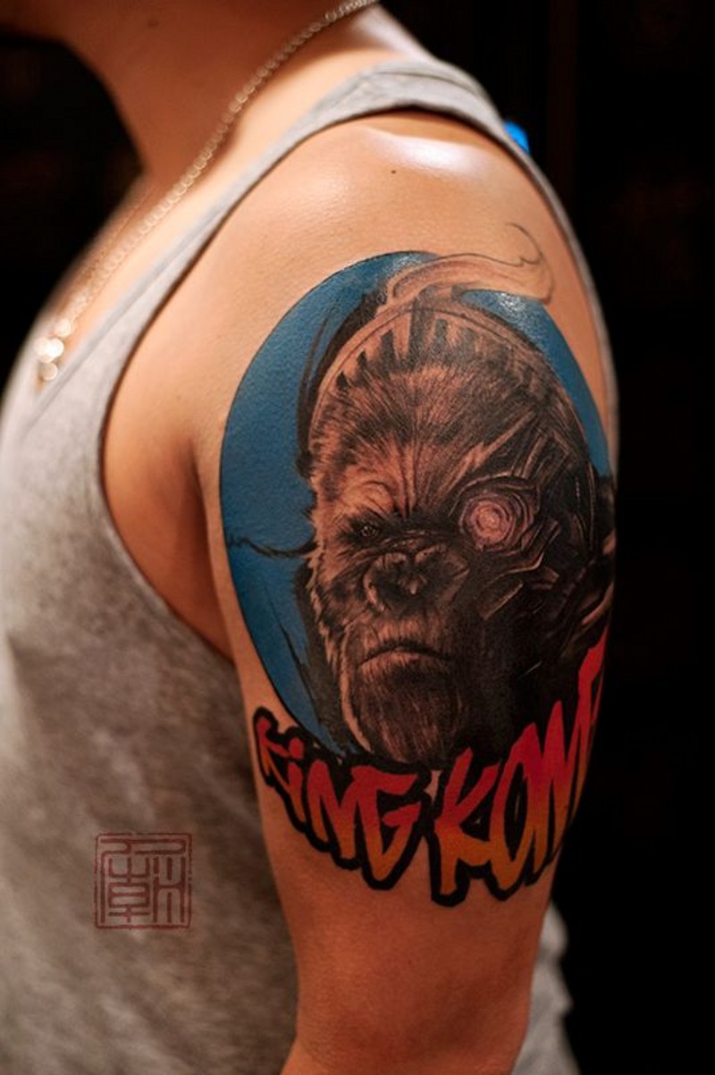 Accurate looking colored monkey portrait tattoo on shoulder with lettering