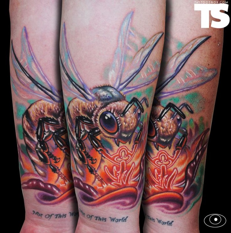 Accurate painted and colored forearm tattoo of flying bee and glowing flower