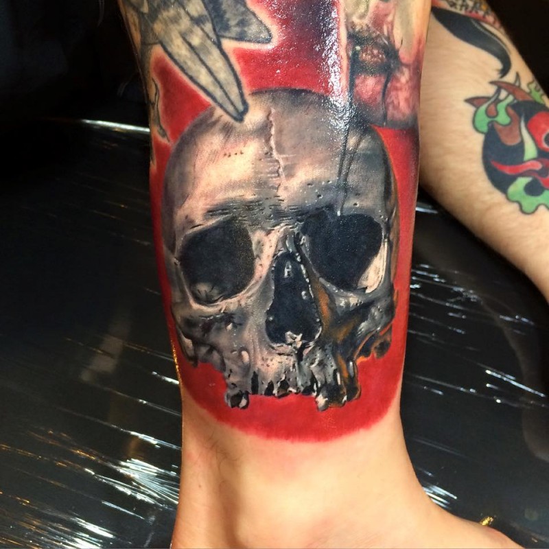 Accurate painted and colored leg tattoo of human skull part