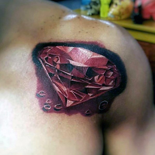 Accurate painted and colored red diamond tattoo on shoulder with shadow