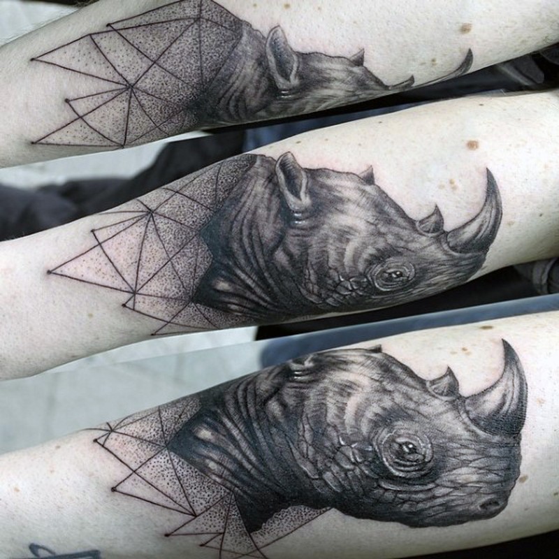 Accurate painted black ink detailed rhino head tattoo on forearm combined with geometrical figures