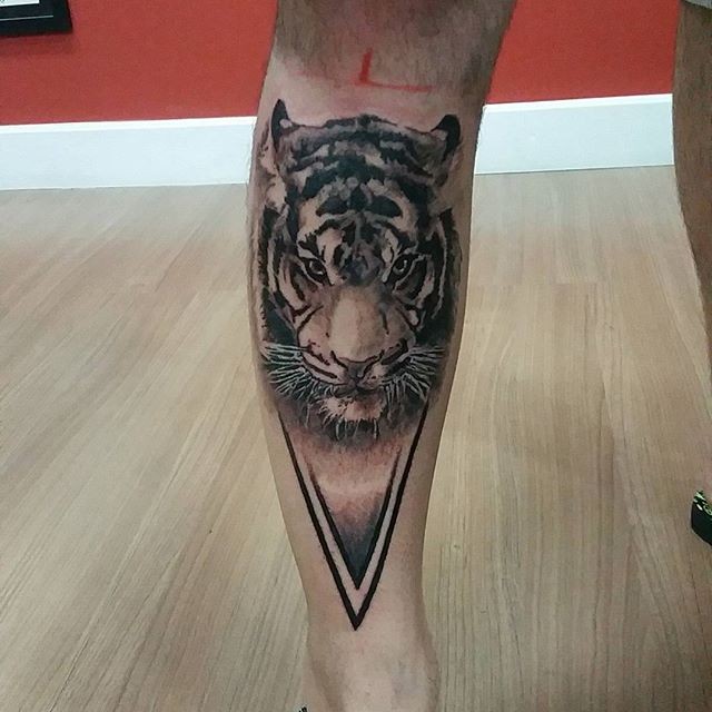 Accurate painted black ink leg tattoo of tiger head with triangle part