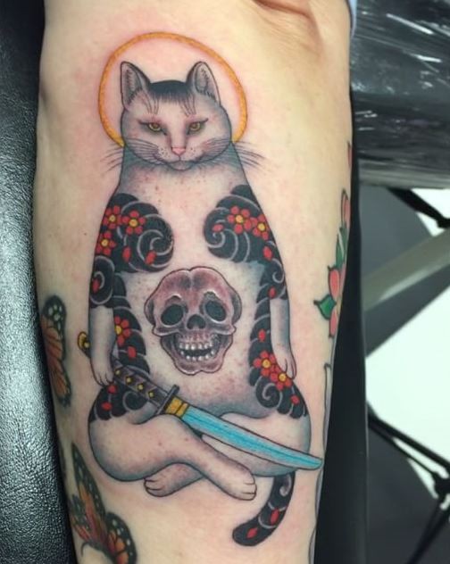 Accurate painted colored arm tattoo of Manmon cat with human skull