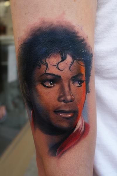 Accurate painted colored arm tattoo of Michael Jackson face